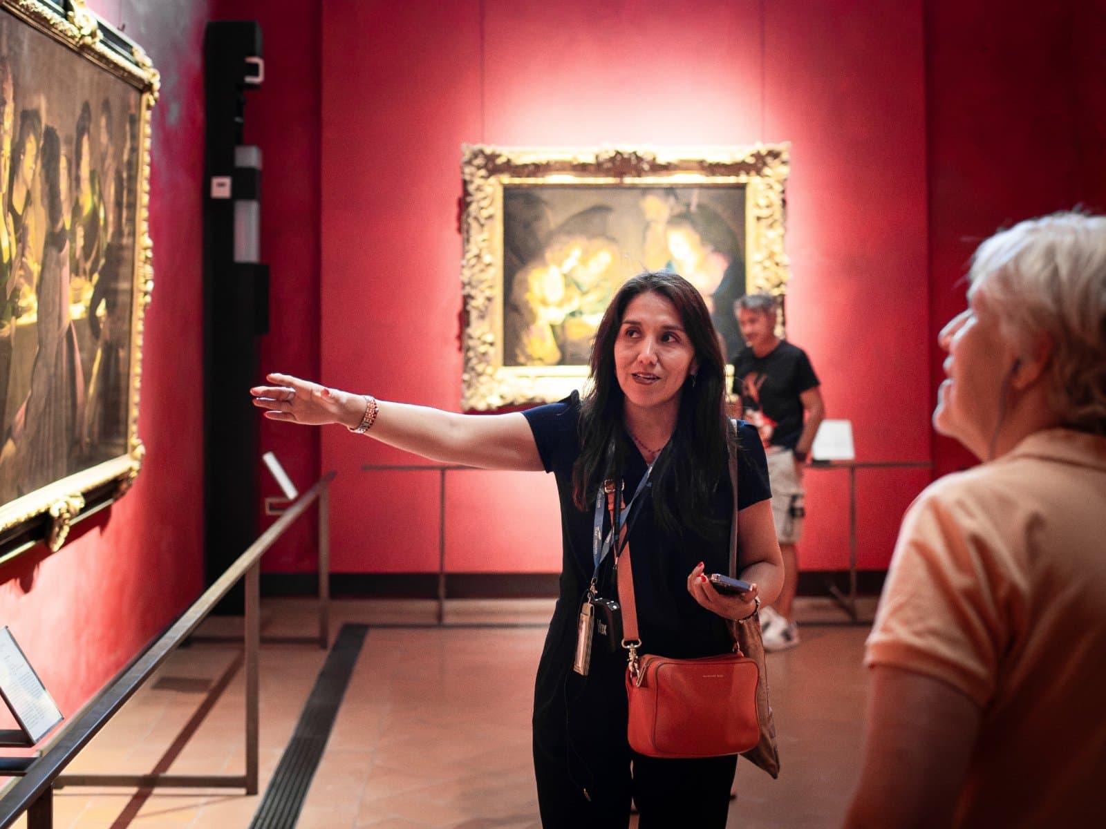 Tour guide indicates artwork in the Uffizi Gallery.