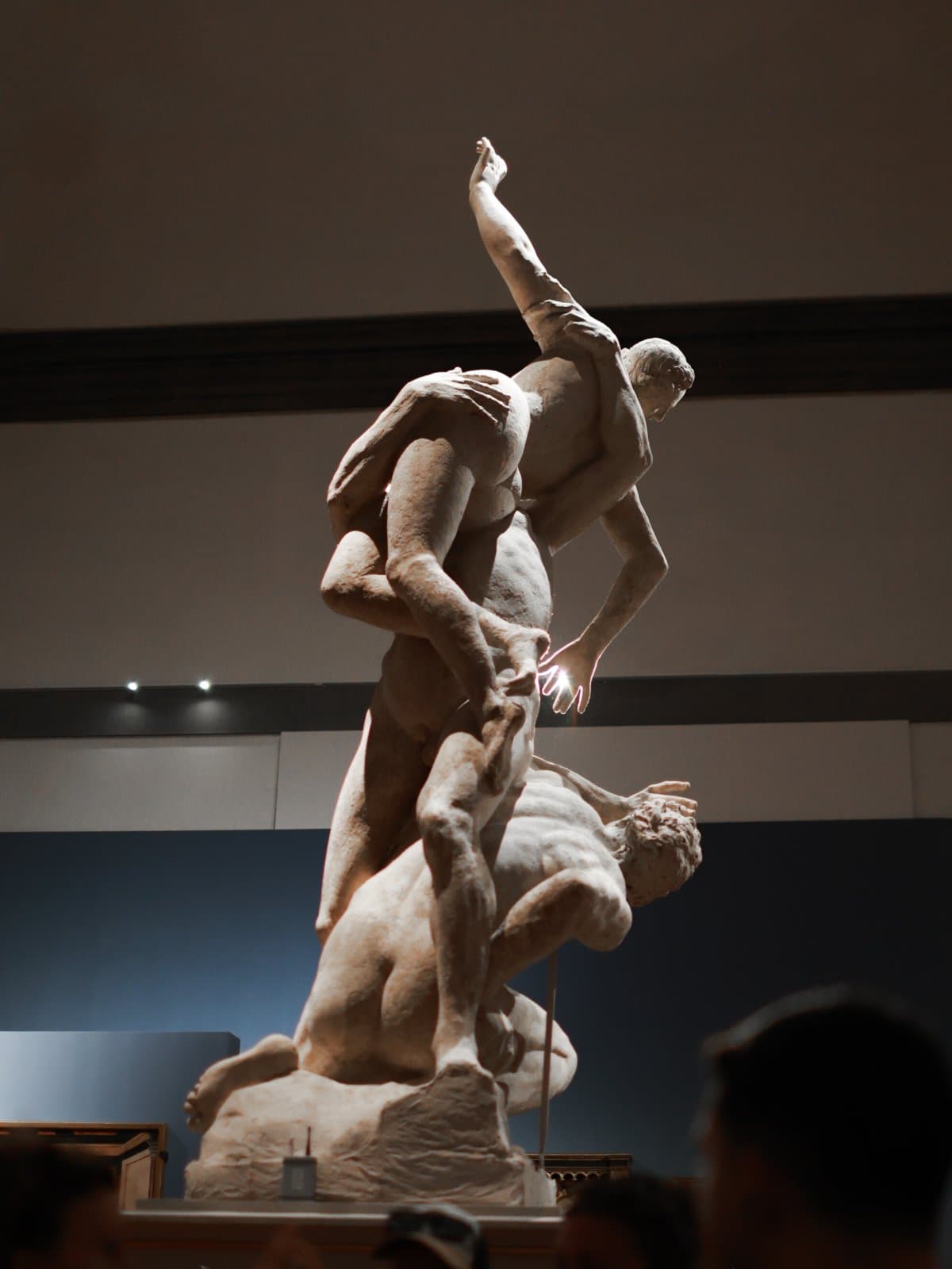 Statue of the Rape of the Sabine Women depicting a young man lifting a woman and with an old man at his feet